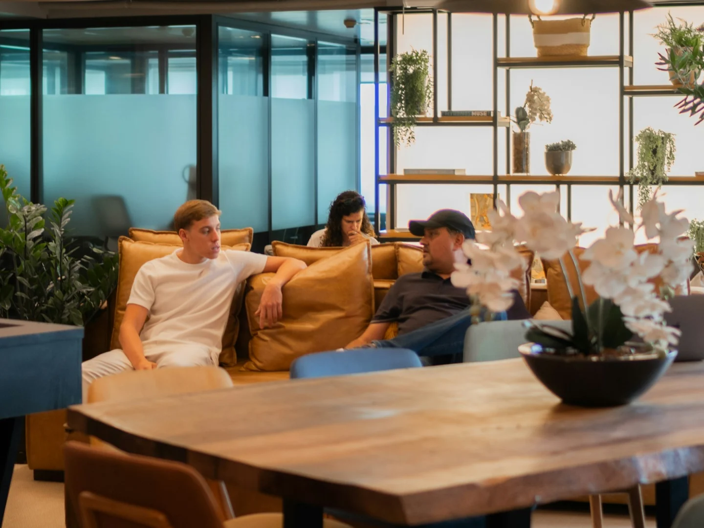 Colleagues sharing an informal conversation in a modern lounge