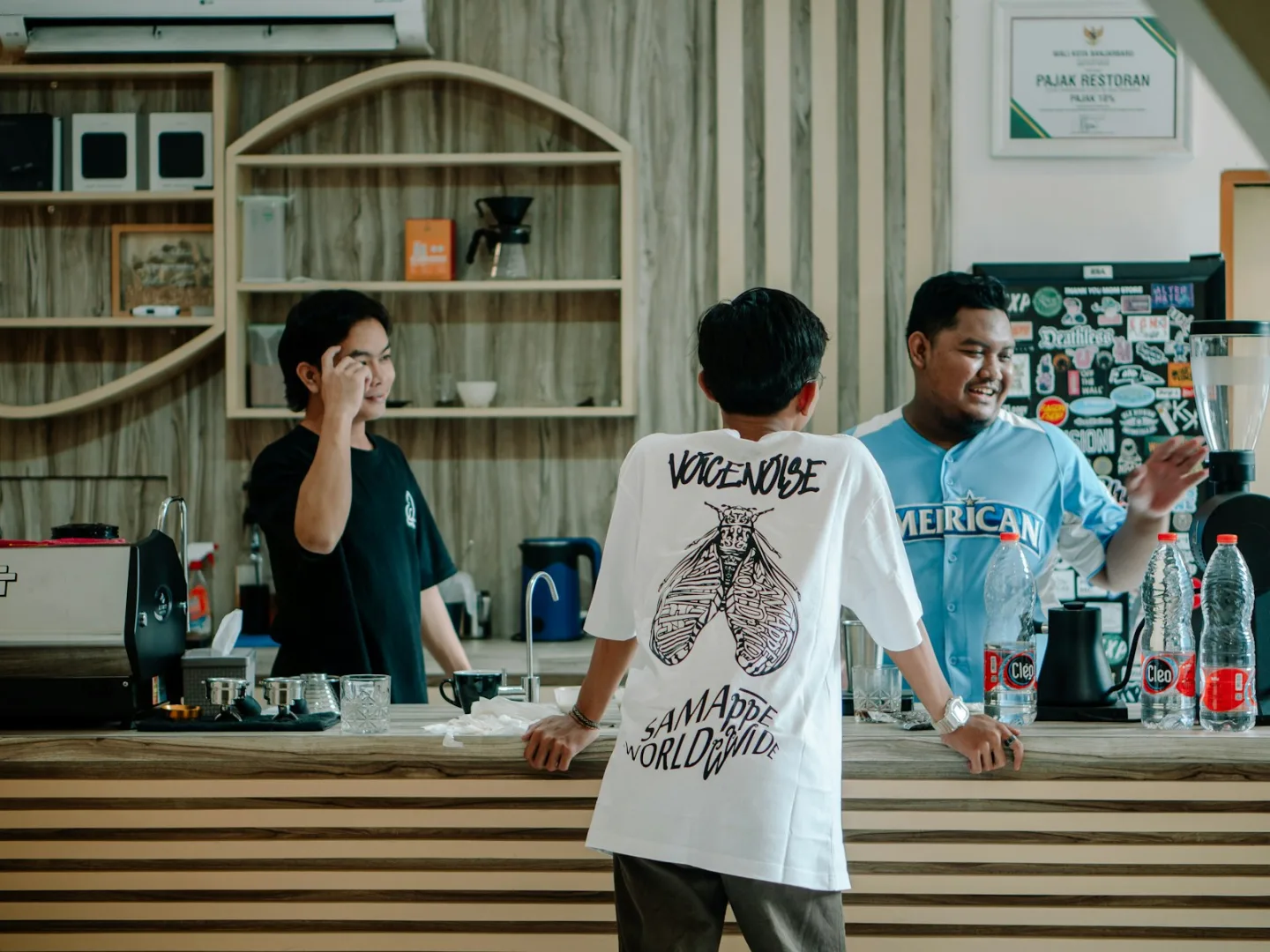 People talking together around a bright café counter