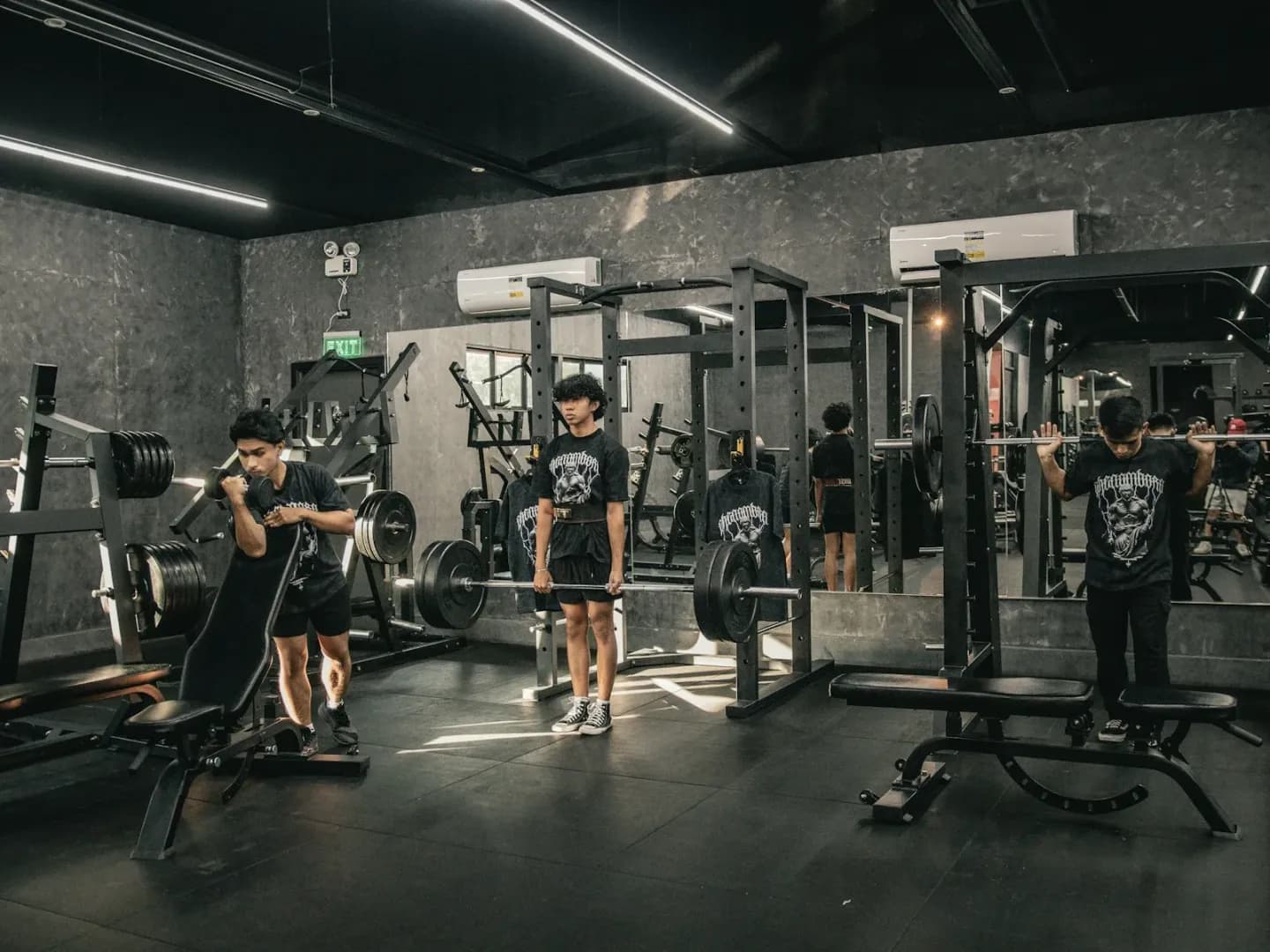 Athletes strength training together in a modern gym